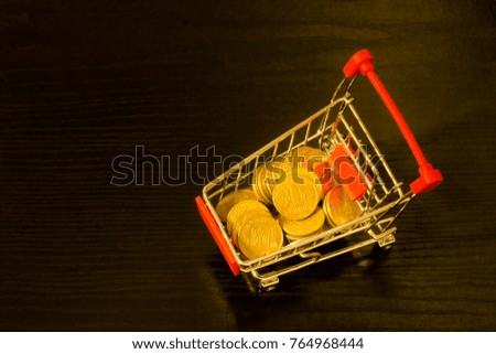 Ukrainian Hryvnia coins in the shopping trolley. Black background