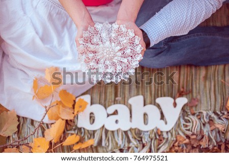 Baby. Letters on a plaid  with autumn leaves