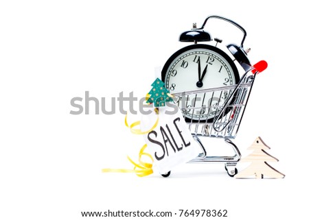 Image of trolley with golden alarm clock, Christmas tree, greeting card, ribbon