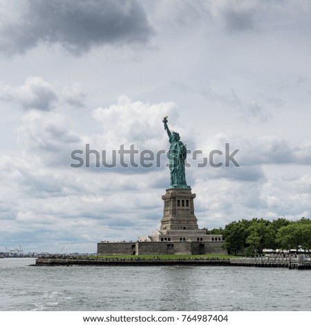 Statue of Liberty with blue sky with clouds
