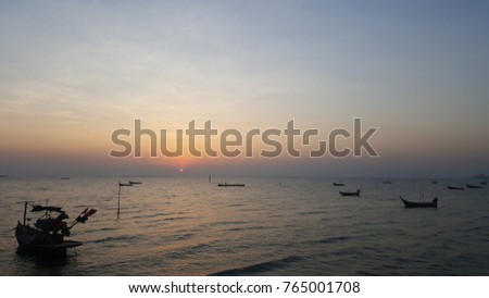 sunset on the sea, small fishing boats in the sea