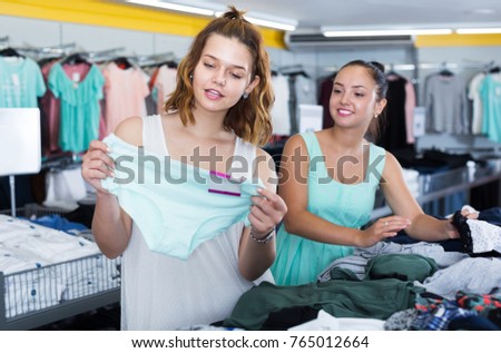 Cheerful young women shopping panties at the apparel store