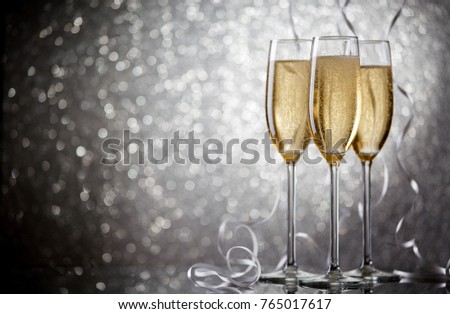 Image of three glasses with wine on gray background