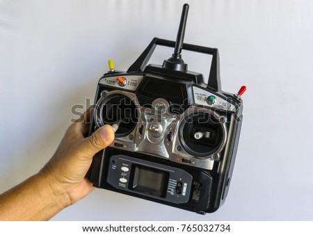 Radio Remote Control for RC planes and RC helicopters isolate on white and on hand.