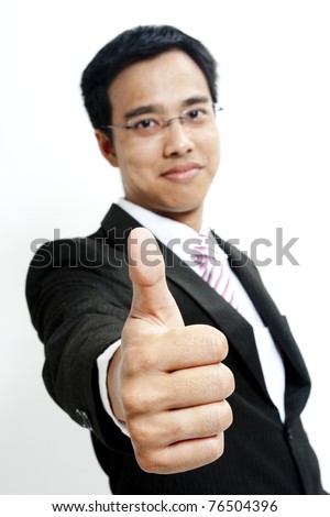 Portrait of a young handsome guy showing goodluck sign against white background