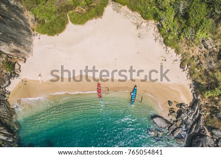 Secret beach Butterfly in Goa, India. Aerial view to pristine beach with rocky bay and waves crashing Royalty-Free Stock Photo #765054841