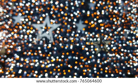 stars and orange bokeh background from Christmas tree.  Flashing bulb,bokeh lights,Light ornamental christmas