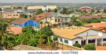 Modern residential buildings in Africa. Modern view. Suburb lifestyle in developing countries. Beautiful urban landscape. Top view. Wonderful houses with red tile roofs.