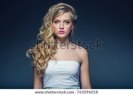 Beautiful blonde Woman Face Portrait Beauty Skin Care Concept. Fashion Beauty Model with beautiful hair over gray background