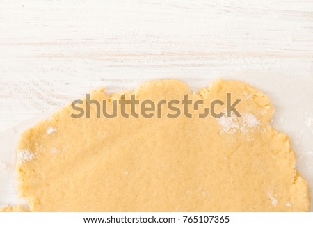 The preparation of the biscuits. The dough for making Christmas cookies. The background image of the process of cookie making.