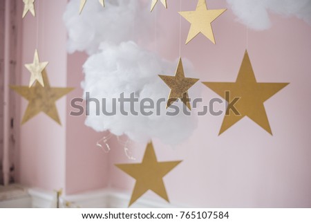 Cotton wadding clouds with stars on pink background