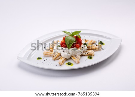 Calamari rings with herbs white garlic cheese sauce and tomato slices. Seafood restaurant menu. Royalty-Free Stock Photo #765135394