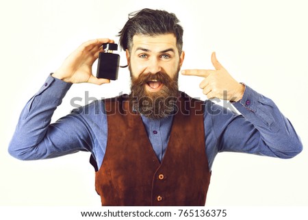 bearded man, long beard, brutal caucasian hipster with moustache holding perfume with happy face isolated on white background