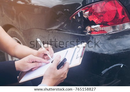 Insurance agent working on car accident claim process Royalty-Free Stock Photo #765158827