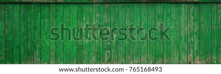 The texture of an old rustic wooden fence made of flat processed boards. Detailed image of a street fence of a rustic type made of wooden material close-up