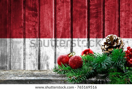 Wooden Christmas background with a flag of Indonesia. There is a place for your text in the photo.