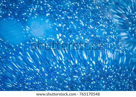 Abstract liquid bokeh or glitter lights  blue  background. Circles and defocused particles. Design template