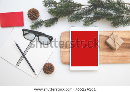 Christmas desk table top overhead space layout at right tablet red isolated for insert photo and graphic on wood left around book open have pencil upper and glasses
