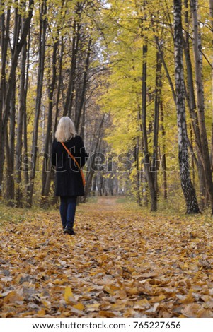 girl walk in autumn park