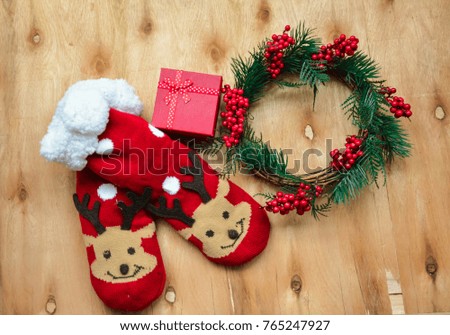 Christmas wreath ,winter socks and a Christmas gift on wooden background