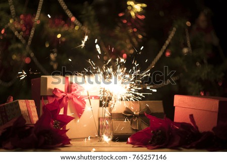 Christmas gift box with holding bengal burning sparkler light