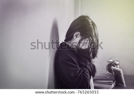 Child lonely alone in an empty room Royalty-Free Stock Photo #765265015