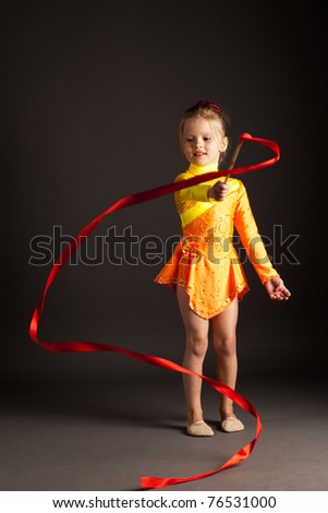 little girl doing rhythmic gymnastics with ribbon