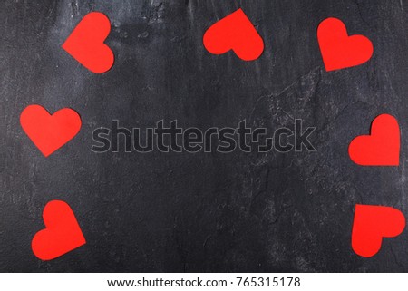 Hearts lie on the perimeter of the arch on a stone background