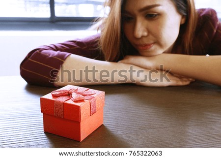 Gifts on the table and women feel happy on background 
