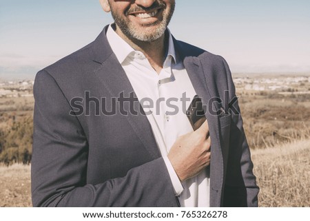 Businessman with mobile phone in hand. It is located in Madrid, Spain.
