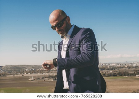 Businessman with mobile phone in hand. It is located in Madrid, Spain.
