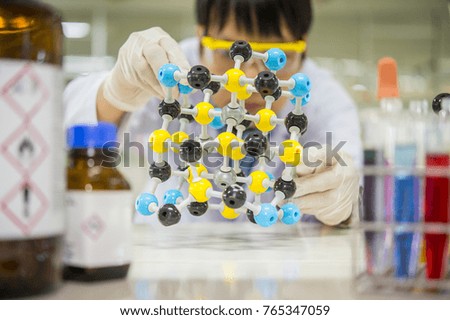 Scientists are studying the molecular structure of chemistry in the laboratory.
