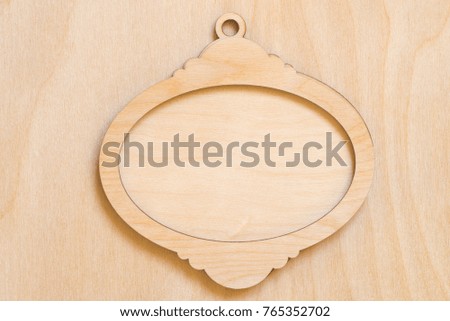 beige empty wooden frame on wood background