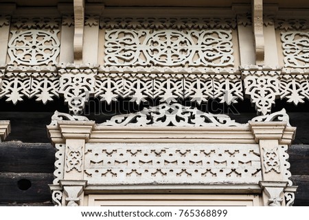 Carved wooden trim facade. Old historic house. Russian architecture. Chopped house with carved wooden architraves. Tomsk, Russia