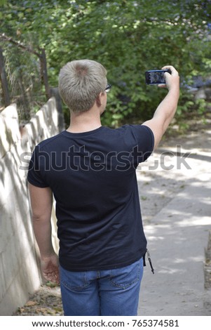 young man takes a picture by phone