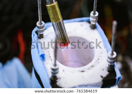 Use fire from gas cans to reduce the cooled temperature of liquid nitrogen in computer overclocking.