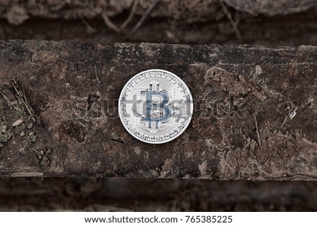 Bitcoin. A new virtual currency comes into use quickly. concept of old money (rusty metal) and silver bitcoin with wonderful future