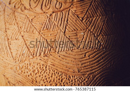 Close-up of traditional handcraft earthenware (Clay pottery) pattern background texture. Selective focus. Blurred background.
