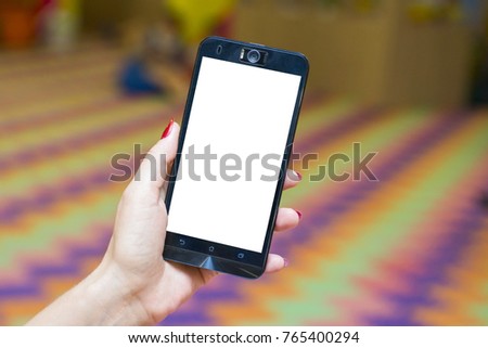 Woman holding smart phone with blurred background. Smart phone with blank screen for your text or content