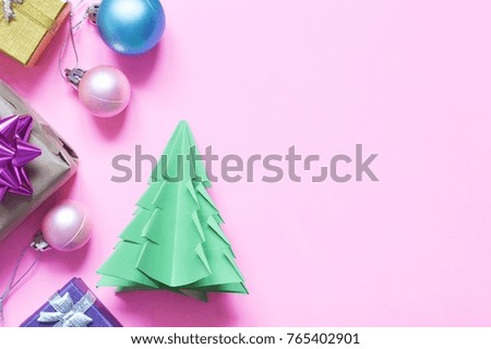 Gift boxes, pink, blue balls and made of paper green Christmas tree. New Year design. Winter holiday home decor ideas. Flat lay photography, top view background