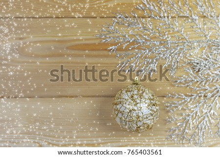 Christmas card with wooden background. Christmas decoration with snowflakes, a pine, a fir tree, a toy and snow. Snow drawn. Greeting card with copy space.