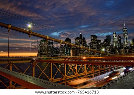 View of sunset over a Lower Manhattan from Brooklyn Bridge.