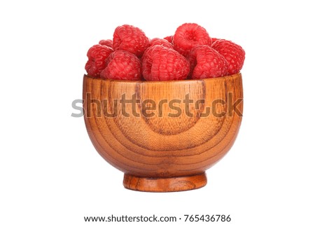 red raspberries in wooden cup isolated