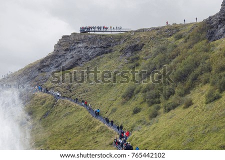 travel to Iceland - tourists on path to viewpoint over Gullfoss waterfall in september