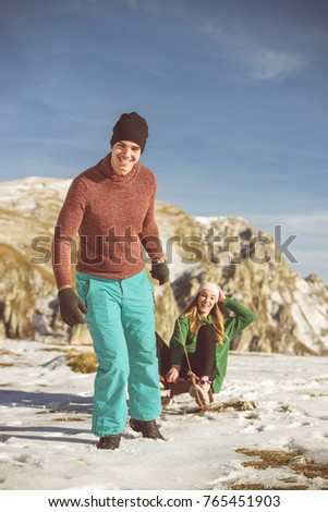 Young couple at mountain looking very happy at the snow