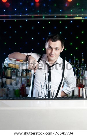 Bartender bartender is pouring a drink Royalty-Free Stock Photo #76545934
