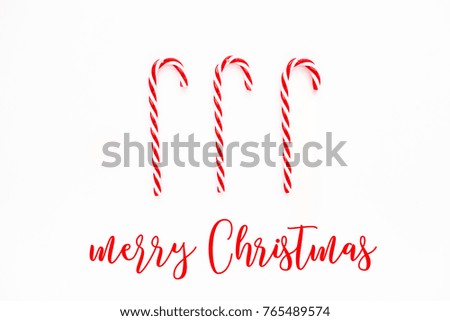 Merry Christmas card with Candy cane. Candies on white background. Flat lay, top view.
