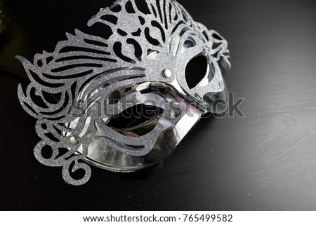 Silver mardi gras mask , Placed on a Black background. Copy space for text. Top view.