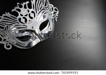 Silver mardi gras mask , Placed on a Black background. Copy space for text. Top view.