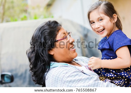 Happy latin mom and little daughter outside. Royalty-Free Stock Photo #765508867